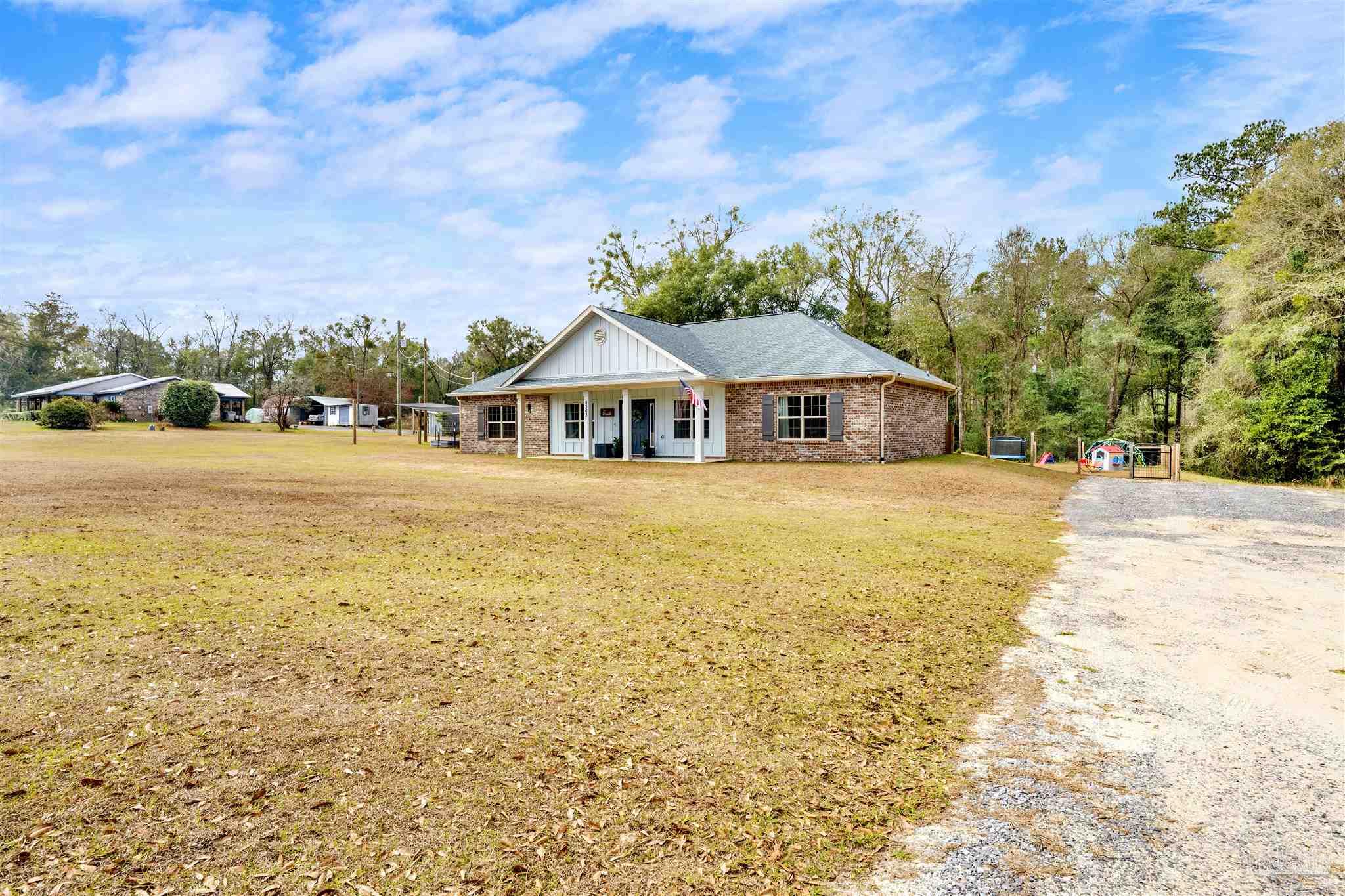 4363 Morristown Road Jay, FL 32565 - Photo 37 of 37 a view of a patio with a table and chairs under an umbrella