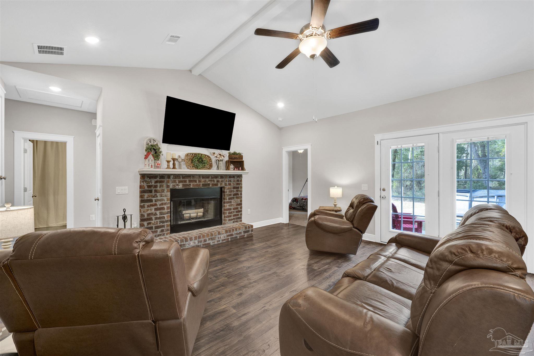 4363 Morristown Road Jay, FL 32565 - Photo 4 of 37 a living room with furniture a flat screen tv and a fireplace