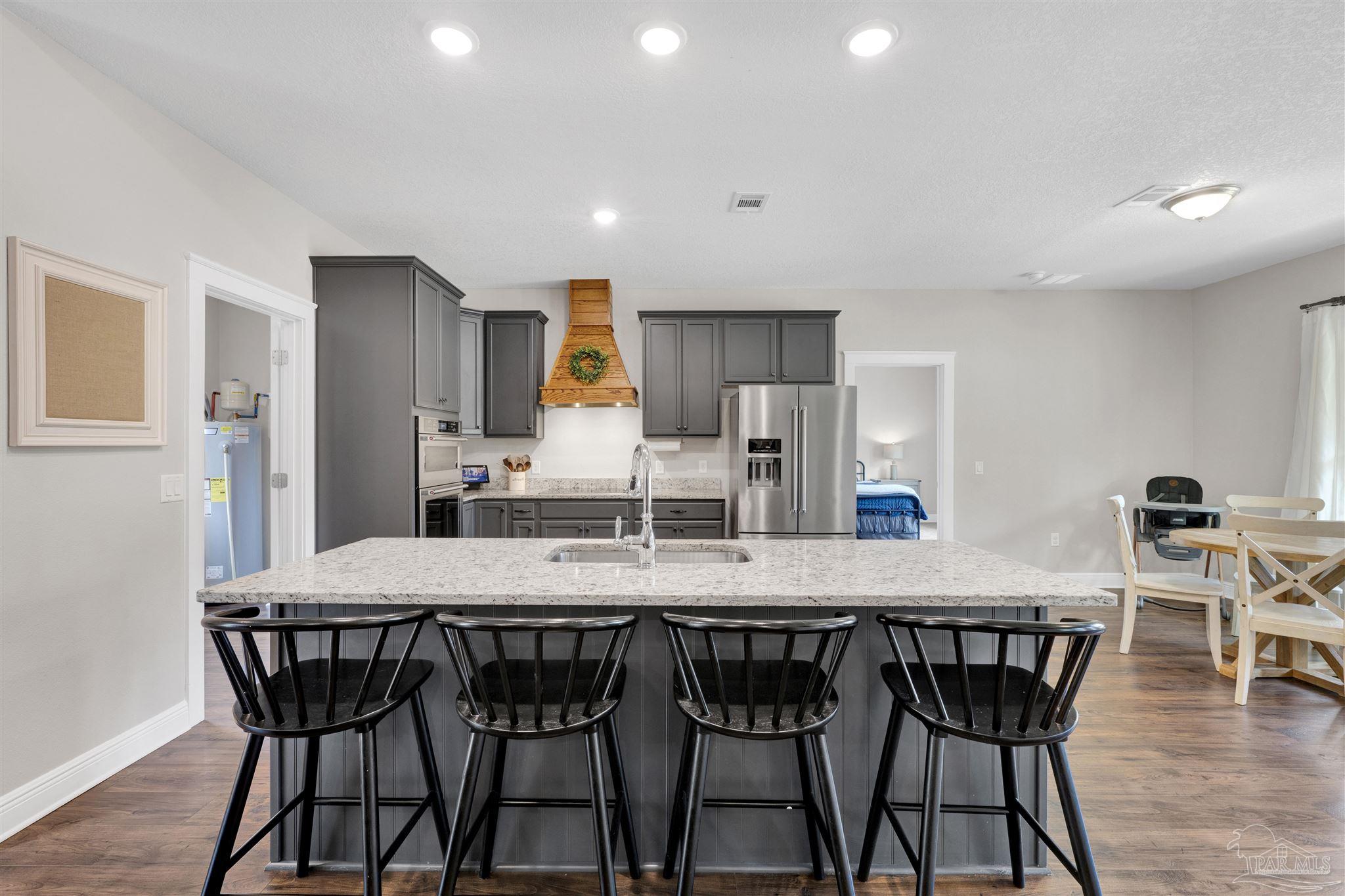 4363 Morristown Road Jay, FL 32565 - Photo 9 of 37 a dining table with chairs and wooden floor