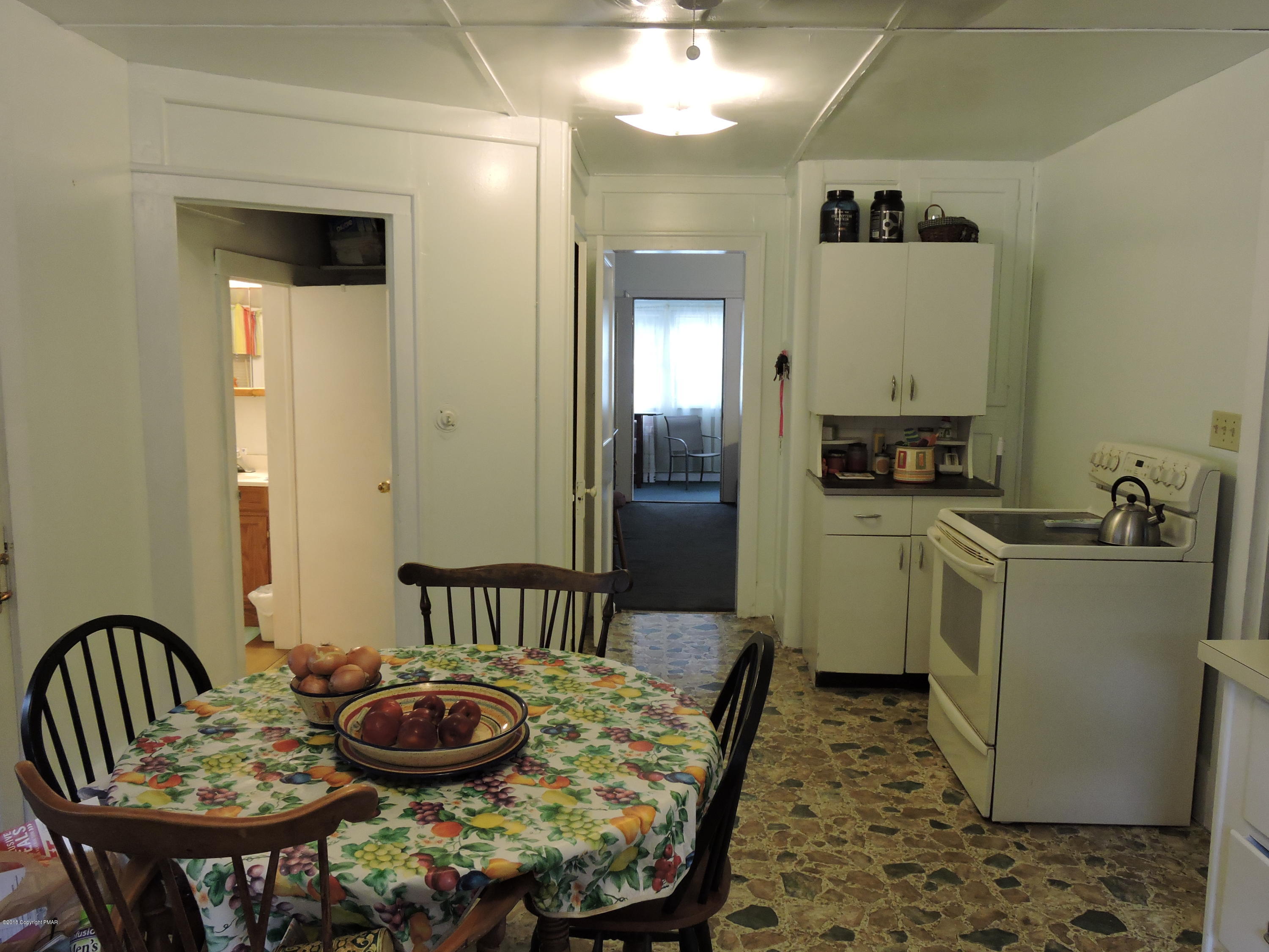 813 Stokes Mill Road Stroudsburg, PA 18360 - Photo 11 of 20 a kitchen with a table and chairs in it