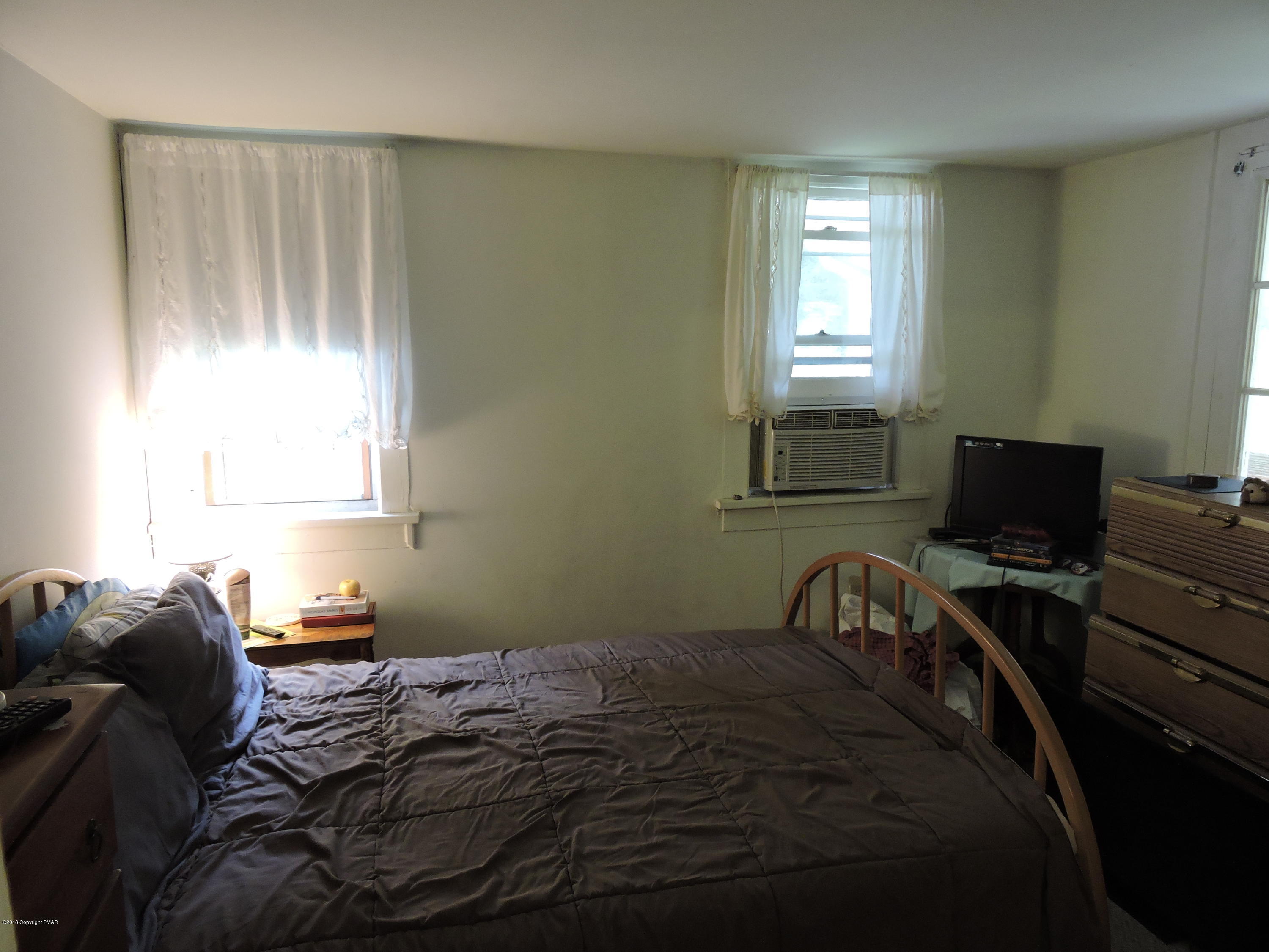 813 Stokes Mill Road Stroudsburg, PA 18360 - Photo 15 of 20 a bedroom with a bed and a window