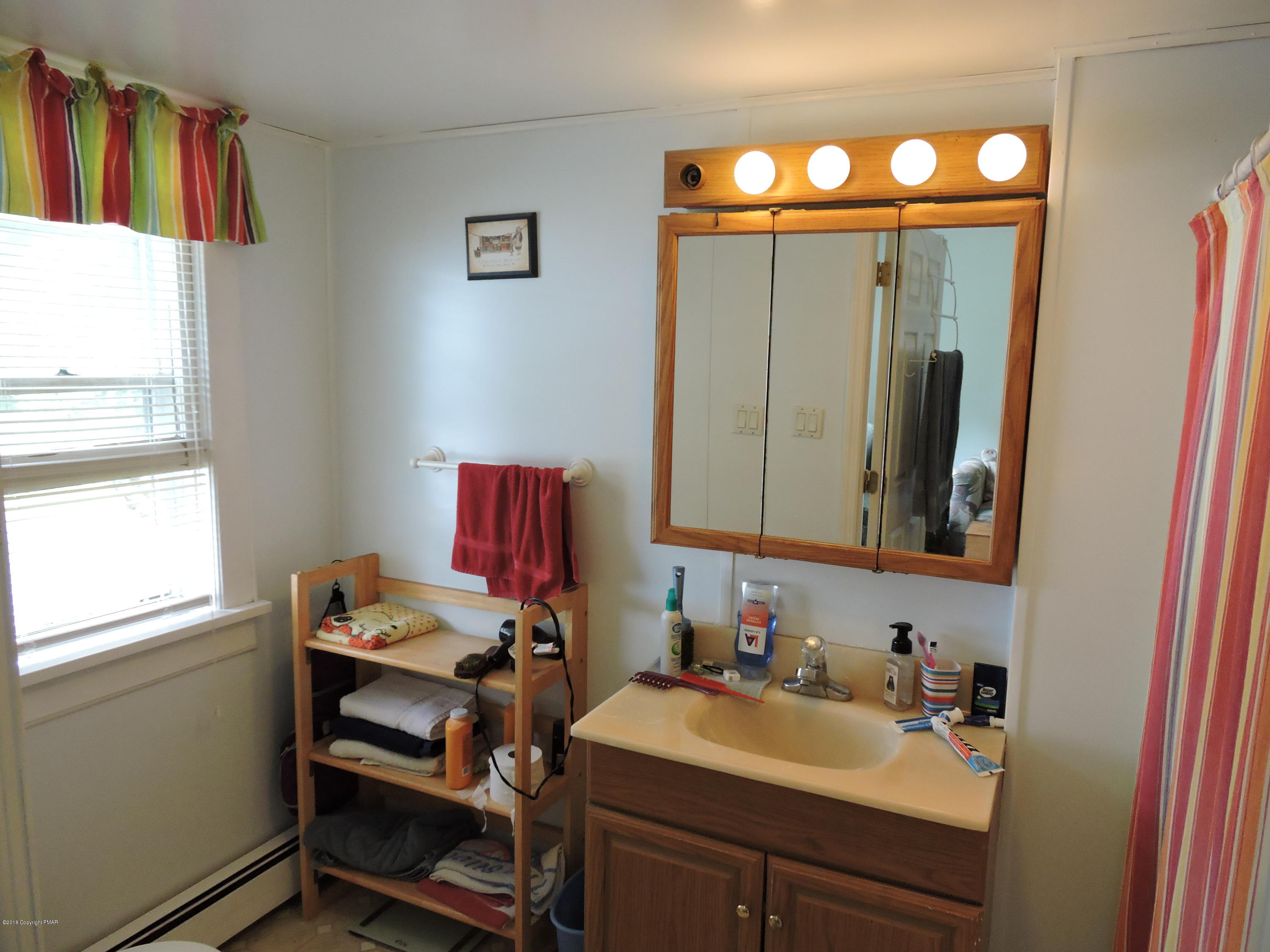 813 Stokes Mill Road Stroudsburg, PA 18360 - Photo 16 of 20 a bathroom with a sink vanity and a mirror