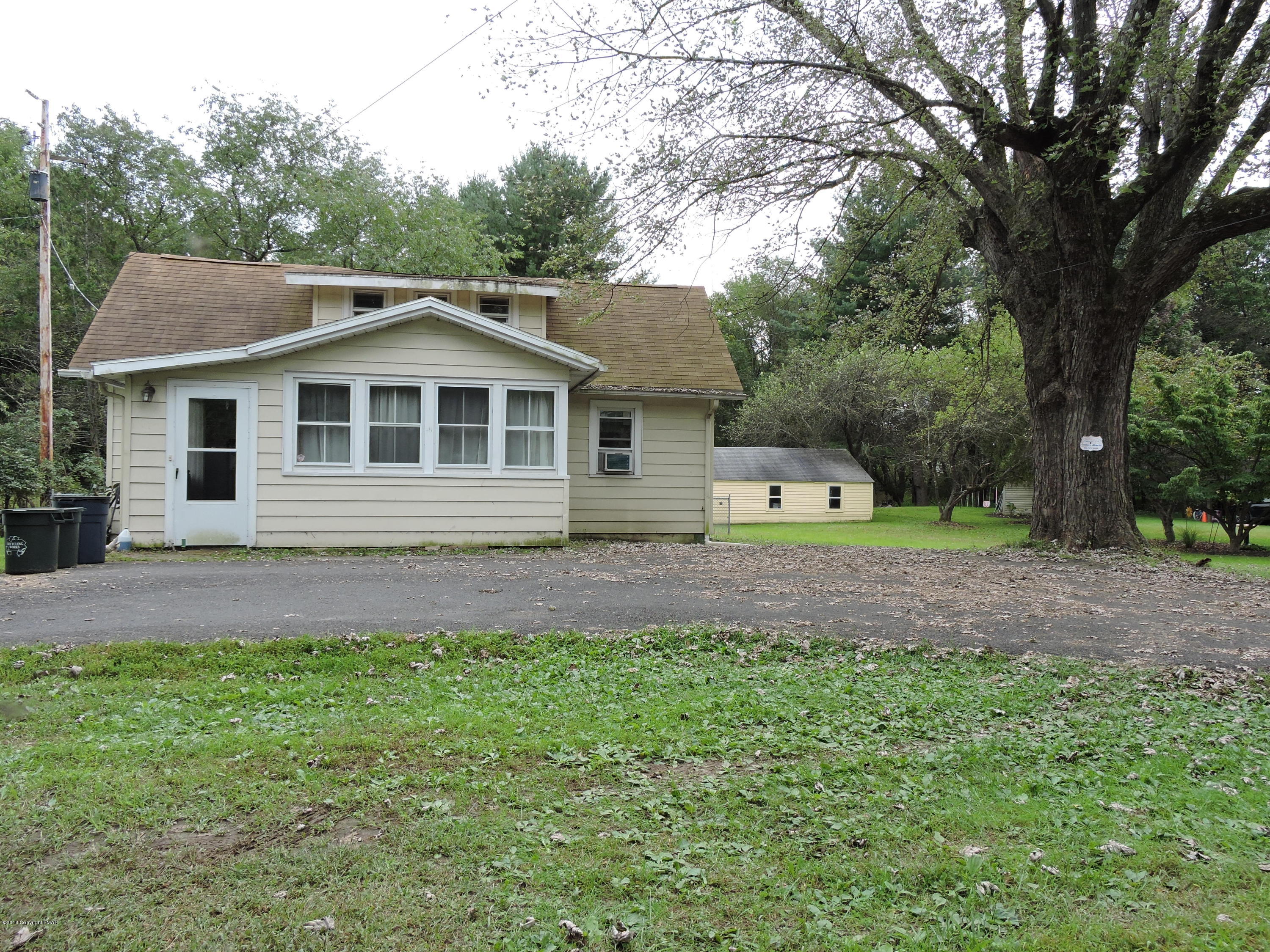 813 Stokes Mill Road Stroudsburg, PA 18360 - Photo 19 of 20 a front view of a house with a garden