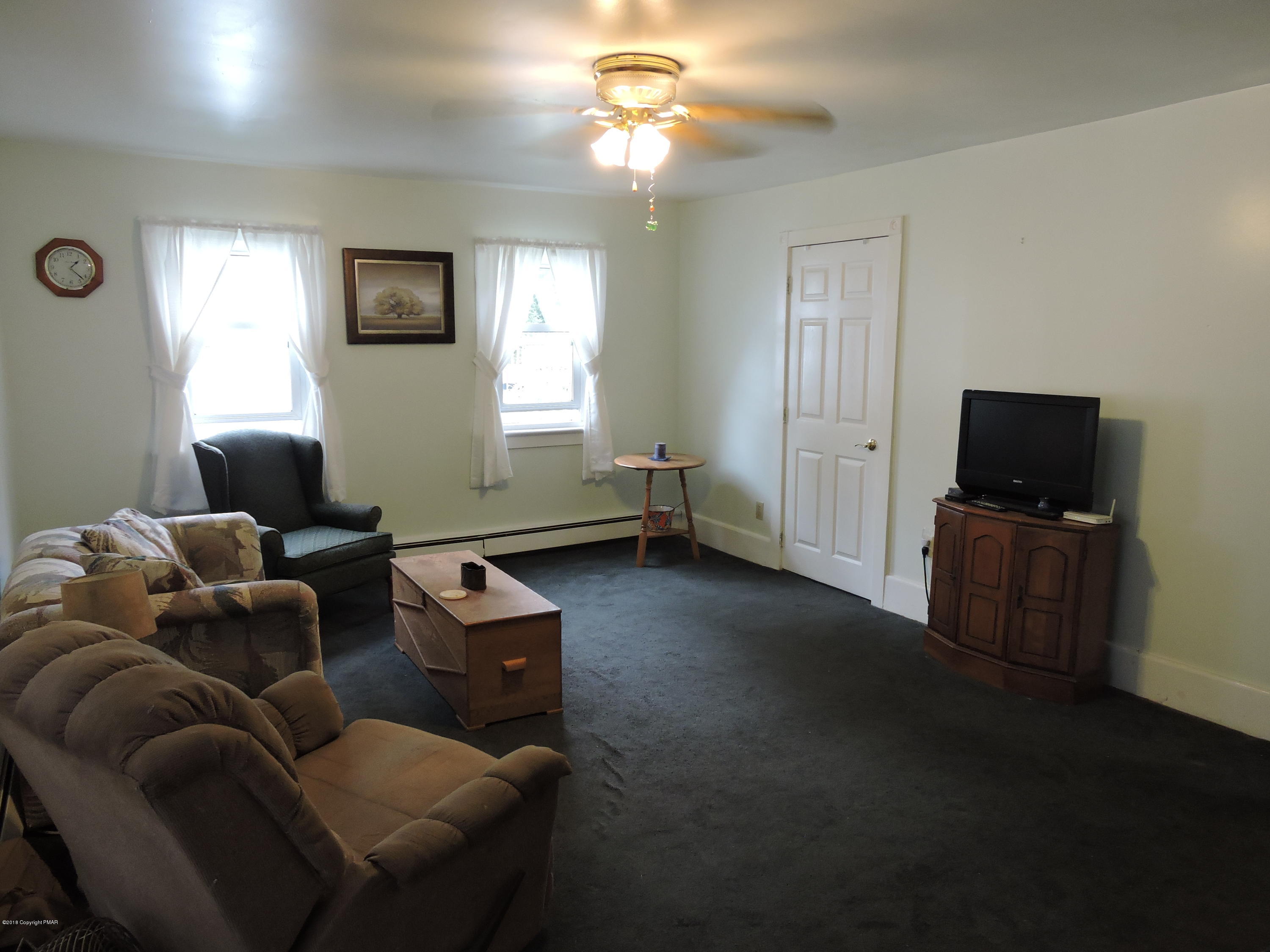 813 Stokes Mill Road Stroudsburg, PA 18360 - Photo 7 of 20 a living room with furniture and a flat screen tv