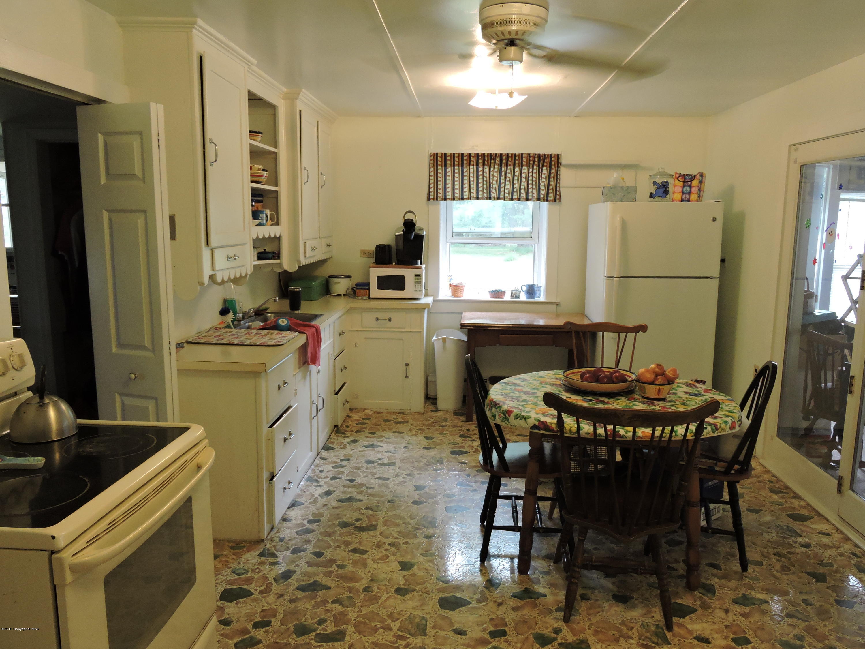 813 Stokes Mill Road Stroudsburg, PA 18360 - Photo 10 of 20 a kitchen with a dining table and chairs
