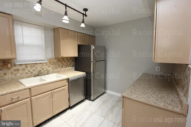 a kitchen with a sink stove and refrigerator