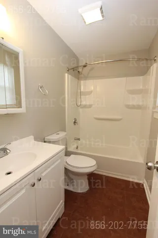 a bathroom with a shower a toilet and a sink
