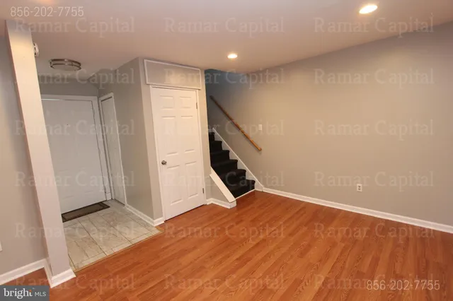 a view of an empty room with stairs and ventilation