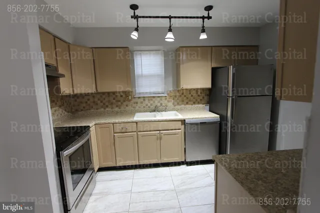 a kitchen with a sink stainless steel appliances and cabinets