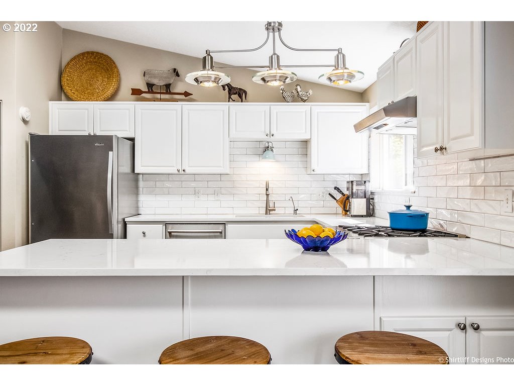 3565 Castrey Street Eugene, OR 97404 - Photo 11 of 30 a kitchen with stainless steel appliances a stove a sink and cabinets