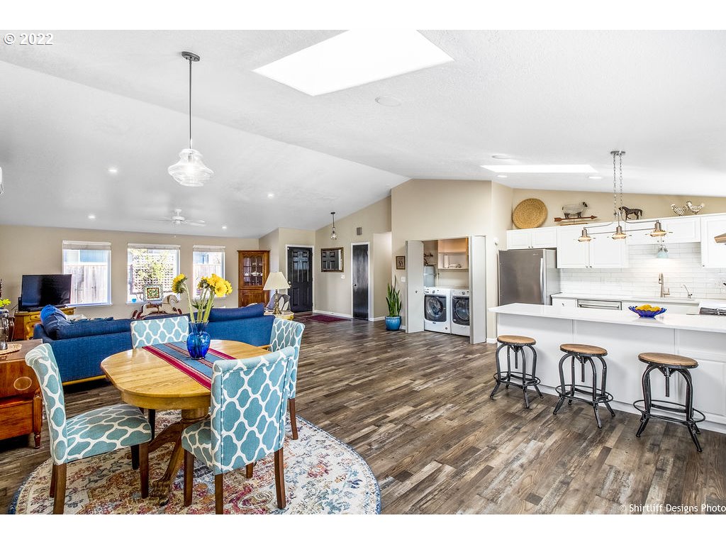 3565 Castrey Street Eugene, OR 97404 - Photo 13 of 30 a living room with furniture a rug and kitchen view
