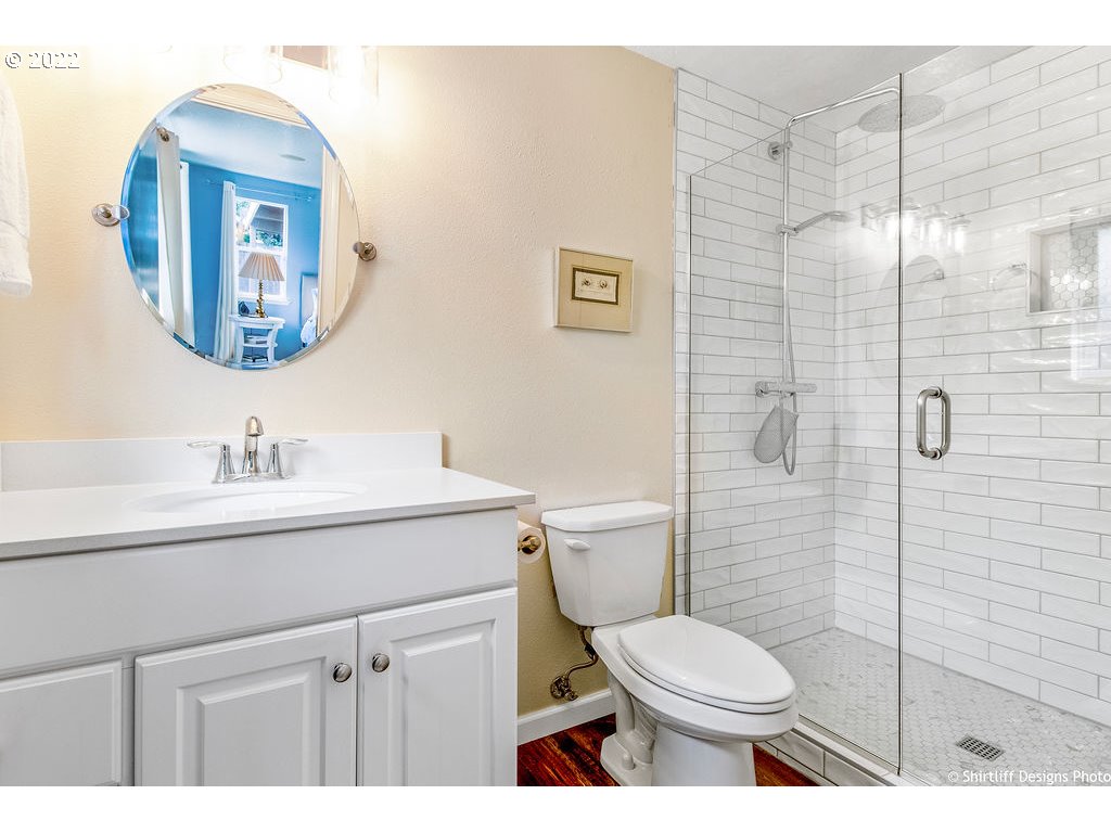 3565 Castrey Street Eugene, OR 97404 - Photo 19 of 30 a bathroom with a toilet sink vanity and mirror