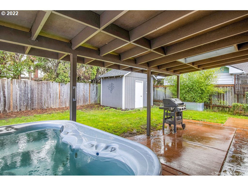 3565 Castrey Street Eugene, OR 97404 - Photo 27 of 30 a view of a backyard with table and chairs under an umbrella with a small yard