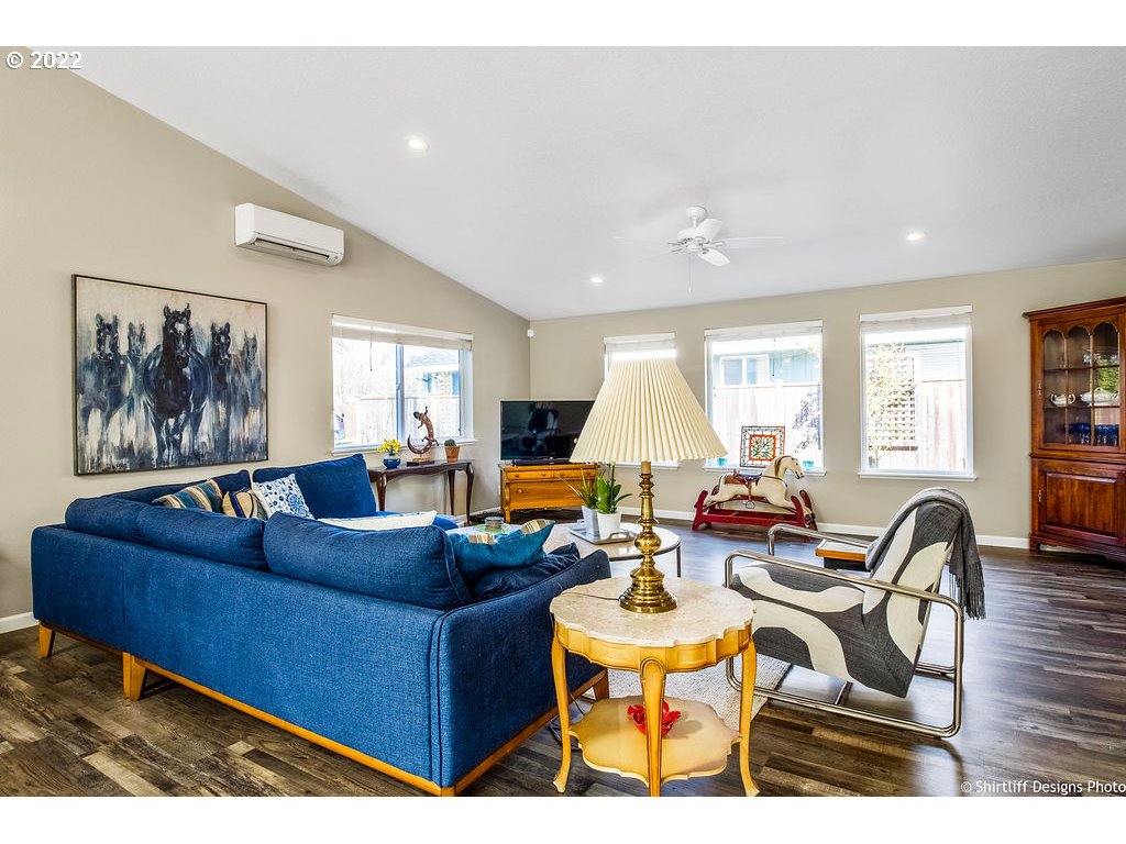 3565 Castrey Street Eugene, OR 97404 - Photo 6 of 30 a living room with furniture a wooden floor and a large window