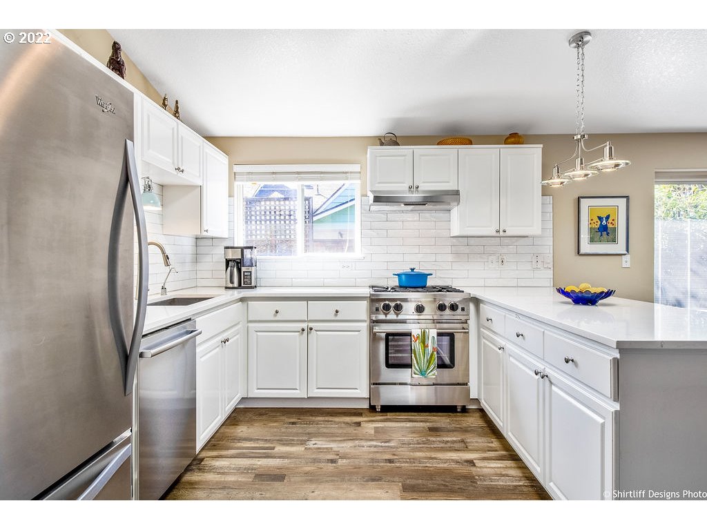 3565 Castrey Street Eugene, OR 97404 - Photo 10 of 30 a kitchen with stainless steel appliances granite countertop a sink stove and refrigerator