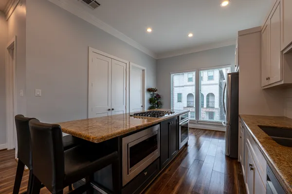 a kitchen with a stove and a refrigerator