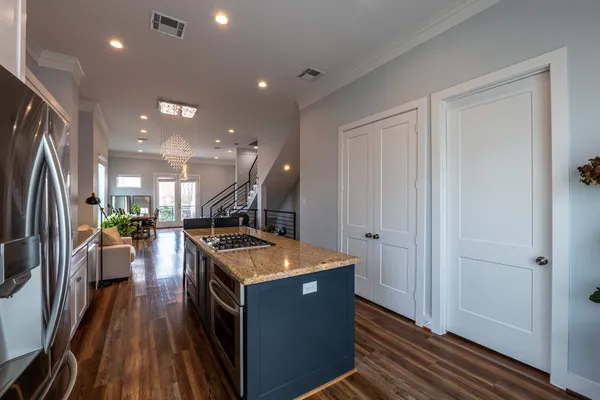 a kitchen with stove and refrigerator