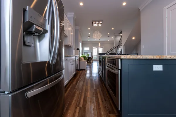 a view of a kitchen with a refrigerator a stove top oven