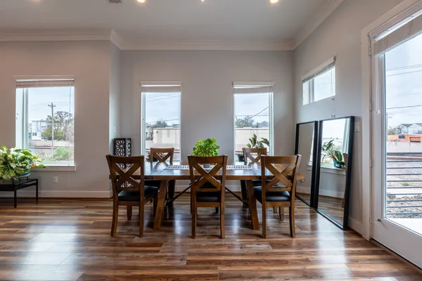 a view of a dining room with furniture window and wooden floor