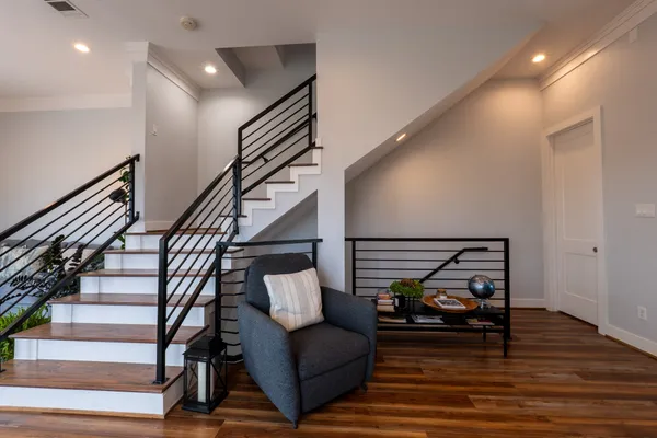 a living room with furniture and stairs