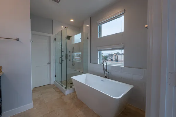 a bathroom with a bathtub and mirror