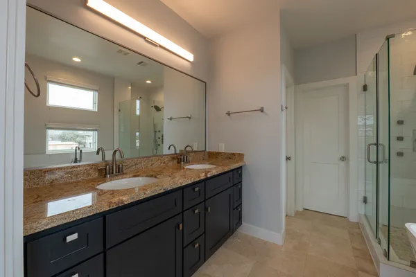 a bathroom with a granite countertop sink mirror and double