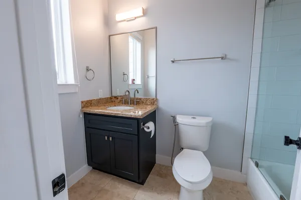 a bathroom with a toilet sink and mirror