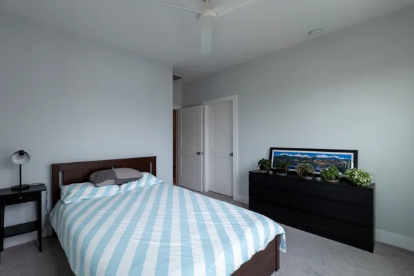 a bedroom with a bed and a potted plant