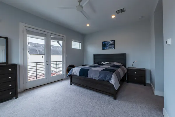 a spacious bedroom with a bed and a window