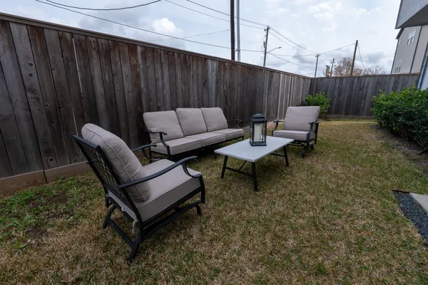 a view of a patio with a table and chairs