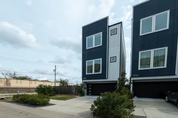 a city view with tall buildings and cars parked in front of it