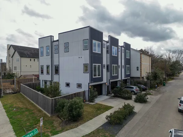 an aerial view of a house with a yard