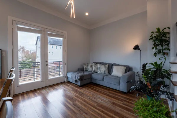 a living room with furniture and a potted plant
