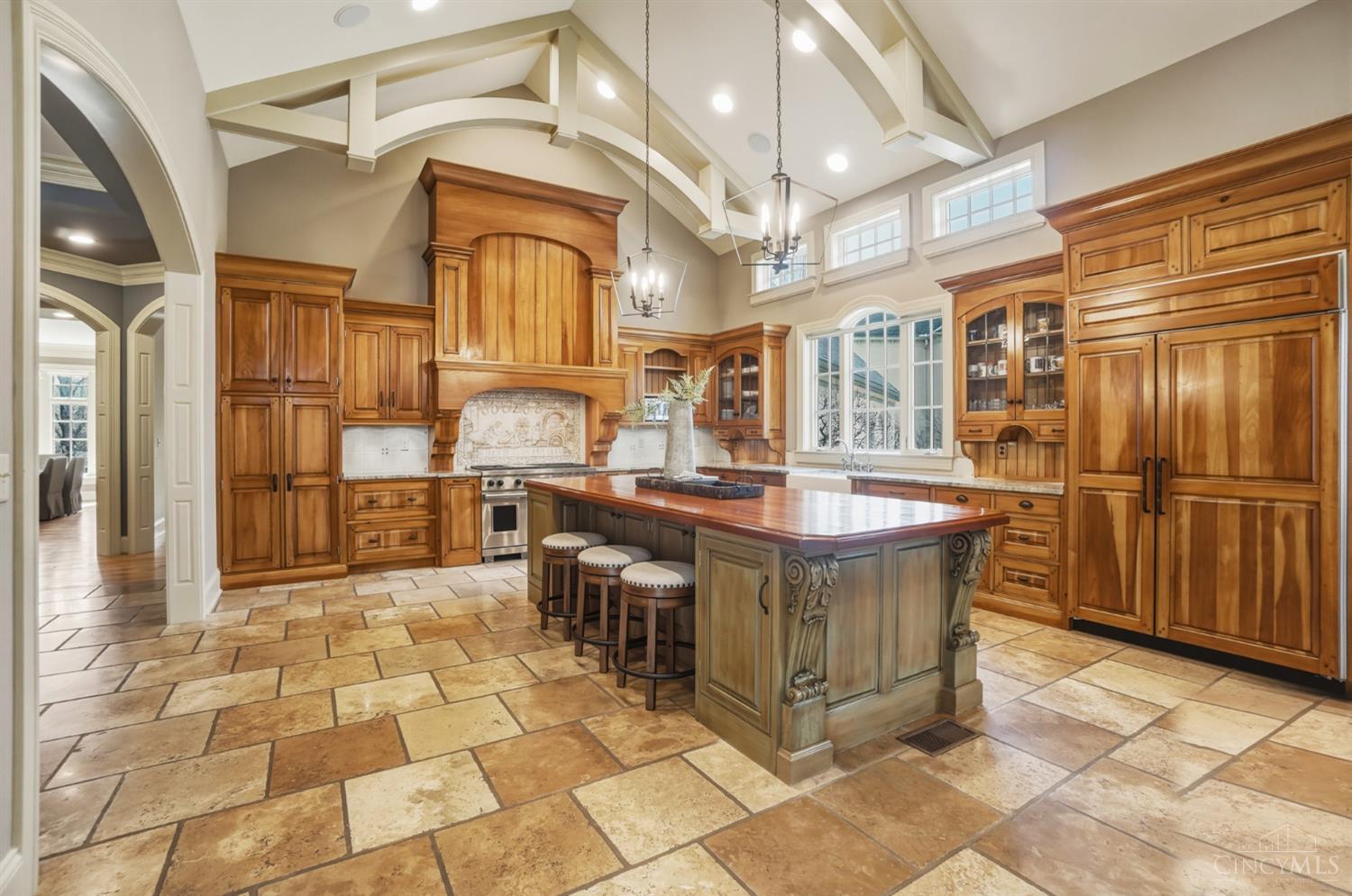 1054 Observatory Point Maineville, OH 45039 - Photo 8 of 82 This kitchen is has wow factor with the vaulted ceiling with beams. Notice the large paneled Subzero refrigerator.