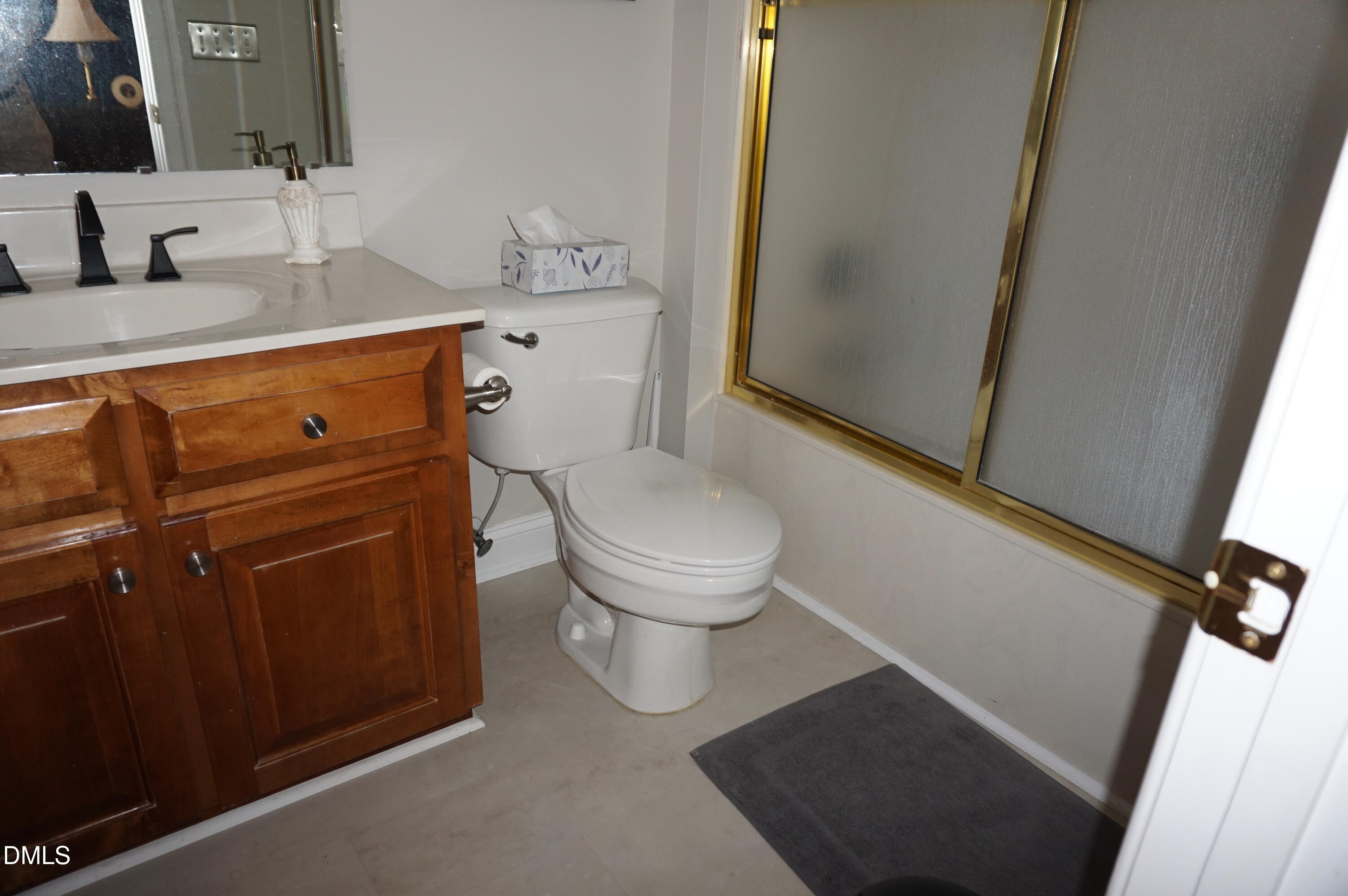 2125 Keith Hills Road Lillington, NC 27546 - Photo 56 of 66 a bathroom with a toilet sink and mirror