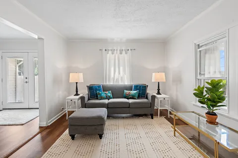 a living room with furniture potted plant and a window