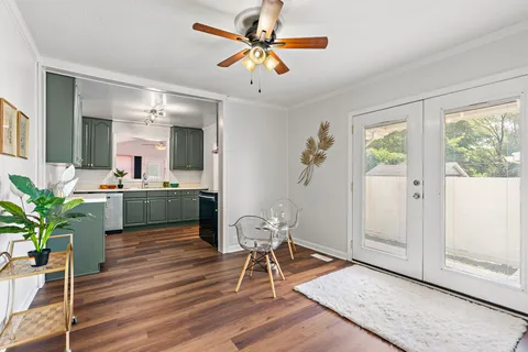 a living room with furniture potted plant and a large window