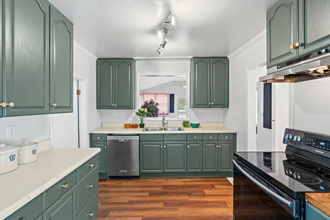 a kitchen with sink cabinets and stove