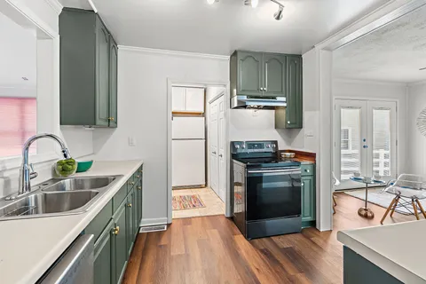 a kitchen with a sink stove and refrigerator