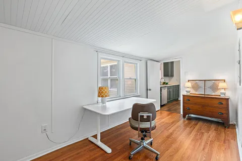 a work room with furniture and wooden floor