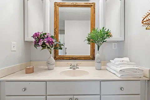 a bathroom with a sink a vanity and a mirror