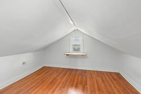 a view of a room with wooden floor and white walls