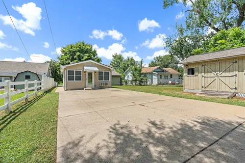 a view of house with outdoor space and shower