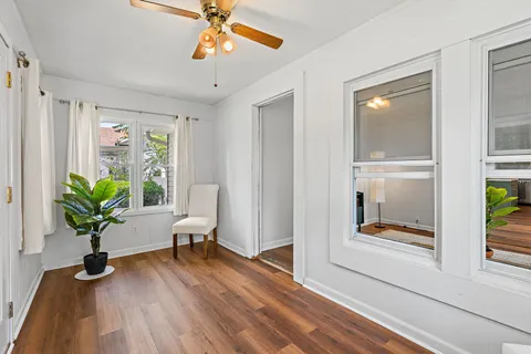 a view of a hallway with wooden floor and glass door