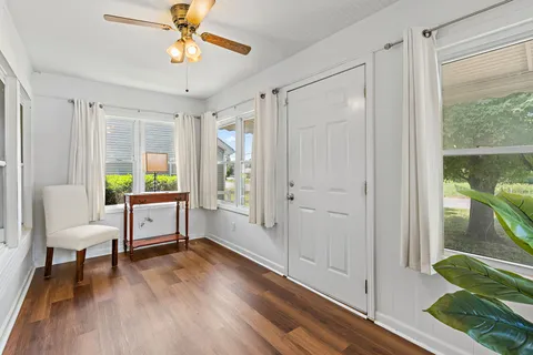 a view of a workspace with furniture and a window
