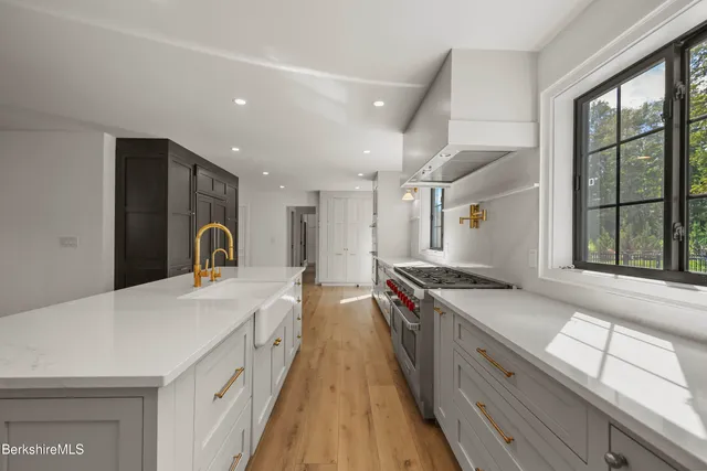 a kitchen with stainless steel appliances kitchen island wooden cabinets and granite counter tops