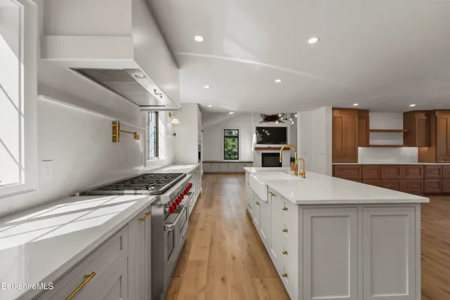 an empty room with fireplace and wooden floor