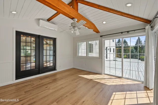 a bathroom with a tub a sink and a window