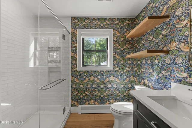 a bathroom with a granite countertop tub sink and mirror