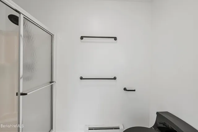 a bathroom with a granite countertop toilet a sink and mirror
